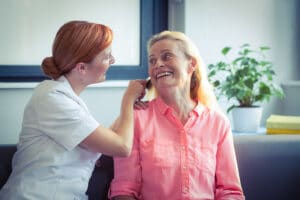 bigstock Female nurse combing hair of s 137416241