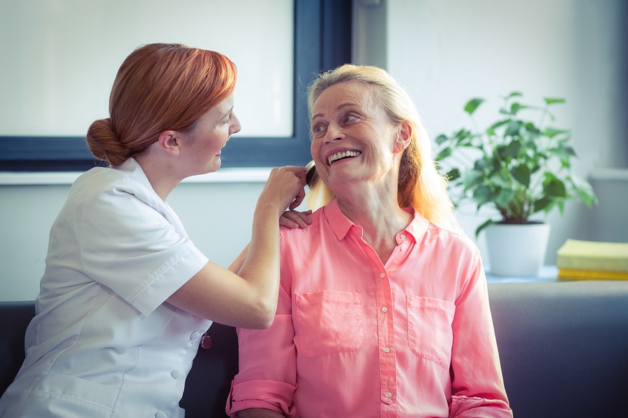 bigstock young woman helps senior man 121214933 bigstock Female nurse combing hair of s 137416241